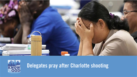 Delegates pray after Charlotte shooting